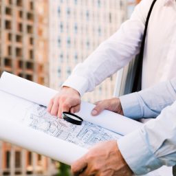 close-up-pessoas-segurando-predios-esboco